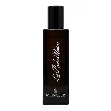 Moncler Les Roches Noires perfume bottle, a dark brown rectangular glass bottle with a black cap, featuring white script and logo text on a plain white background.