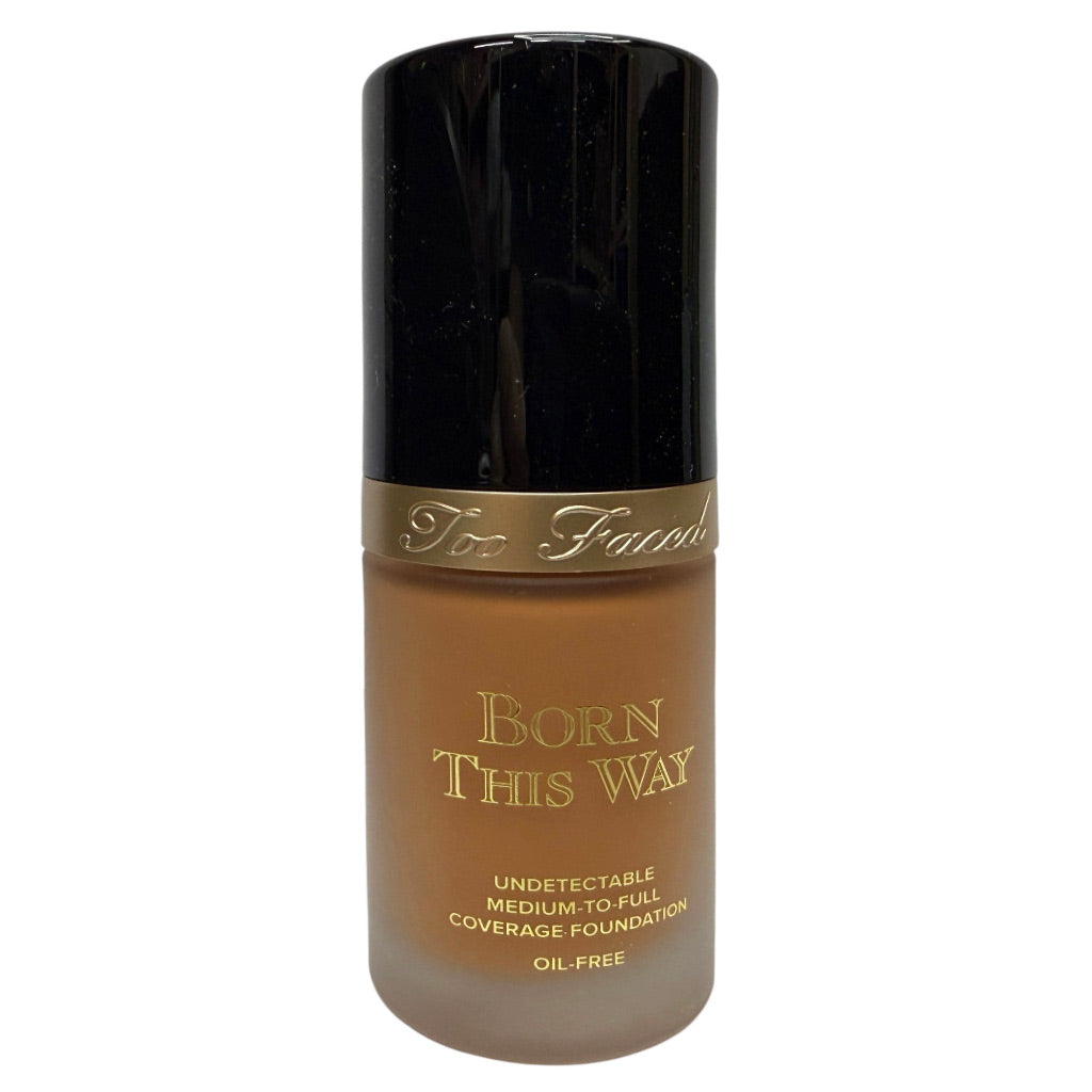 Too Faced Born This Way Undetectable Medium to Full Coverage Foundation in a clear bottle showing the liquid foundation color, with a black cap and gold lettering.