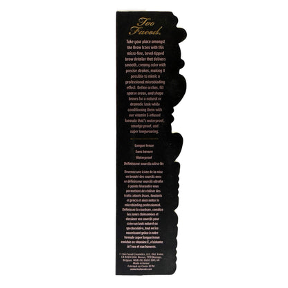 The back of a Too Faced Eye brow detailer product box, showing product description text in black and white on a black background.