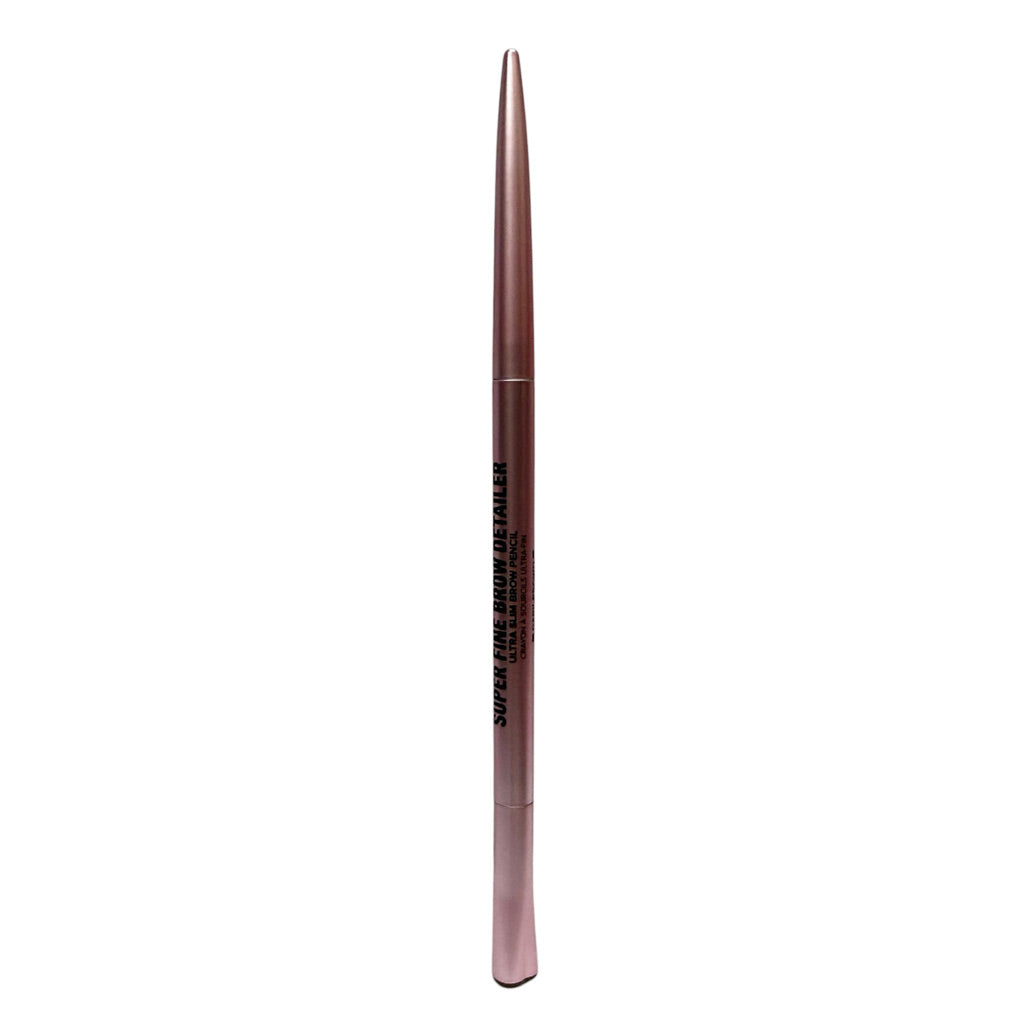 A single eyebrow pencil with a metallic rose gold casing, featuring black text that reads 'SUPER FINE BROW ENHANCER' and 'PRO MAXED OUT', shown vertically against a plain white background.
