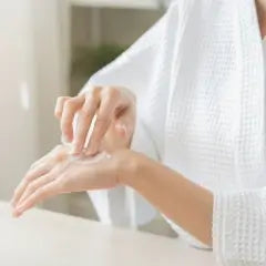 Woman applying a skincare product